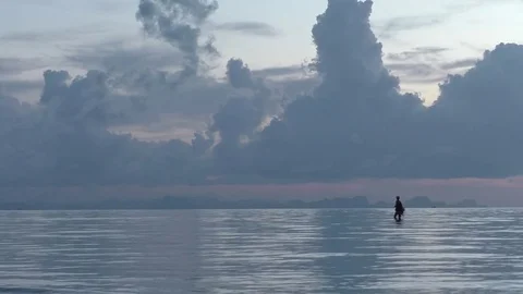 A man walks down the ocean Stock Footage 71832806