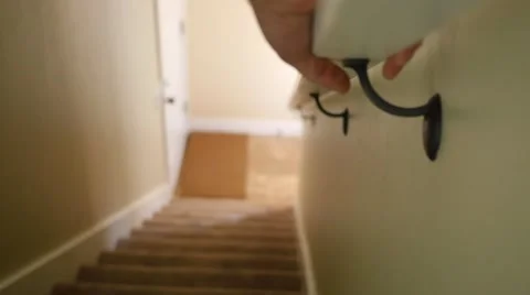 Man walks down stairs and uses hand rail Video stock 57648086
