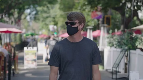 Man walks down State Street in Santa Barbara during the covid-19 pandemic Video stock 143675250