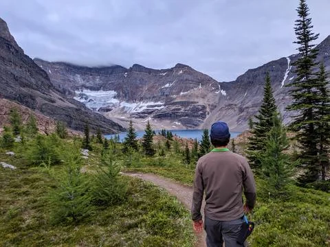 A man walks down a trail towards Lake McArthur in the Rocky Mountains Stock Photos
