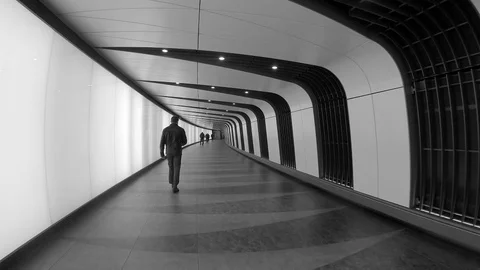 Man walks down tunnel in slow motion 스톡 동영상 107056579