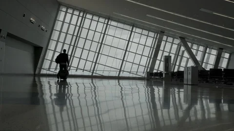 Man walks in an empty airport Stock Footage 129345596