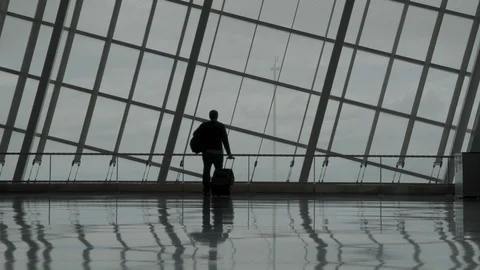 Man walks in an empty airport Stock Footage 129346074