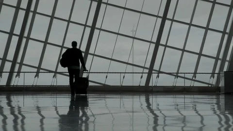 Man walks in an empty airport Stock Footage 129346108