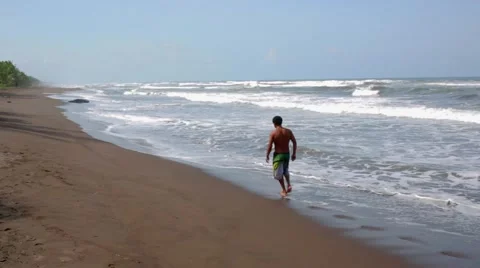 Man walks on empty beach Stock Footage 41870932