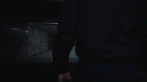 A man walks in the evening lighted underpass Stock-Footage 131401038
