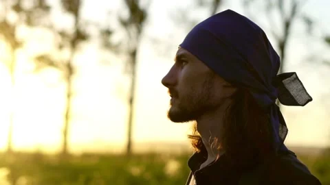 A man walks on a field at sunset Stock Footage 133485887