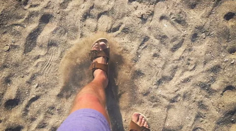 A man walks in flip flops on the sand near the sea (slow motion) Stock Footage 64605306