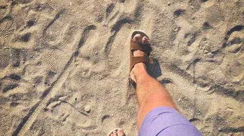 A man walks in flip flops on the sand near the sea (slow motion) 動画素材 64606572