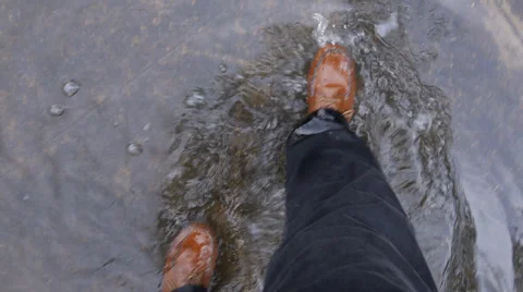 Man walks in  flooded sidewalk or street - slow motion steps in flood Stock Footage 28301776