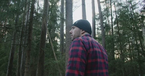 Man walks in the forest Back View of Walking Person. Adventure Trip in Natural Stock Footage 128525302