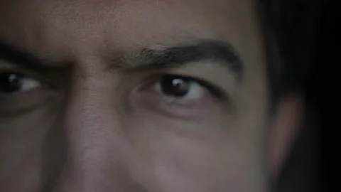 A man walks into frame and have only his eye in focus,looking for something  Stock Footage 167293879