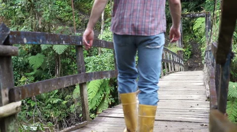Man Walks on Hanging Bridge Going Stock Footage 56564587