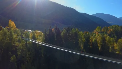 Man walks on hanging rope river bridge in forest 스톡 동영상 120129997