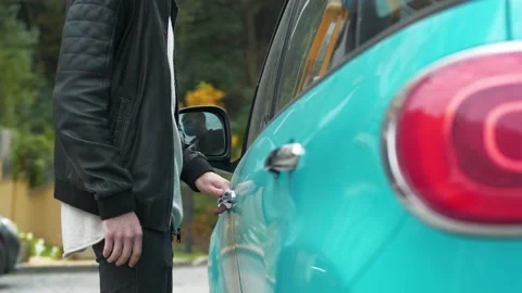Man walks up to a his car, pulls door handle, realizes that he has forgotten key Stock Footage 144842965