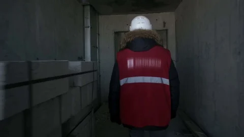 Man walks inside a house under construction Stock Footage 82070286