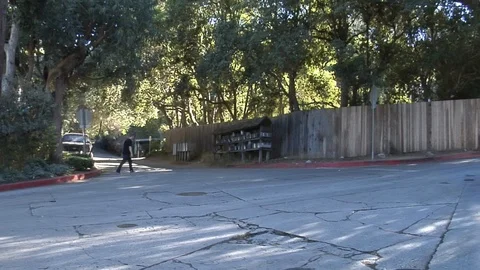 Man walks to mailboxes Stock Footage 99604231