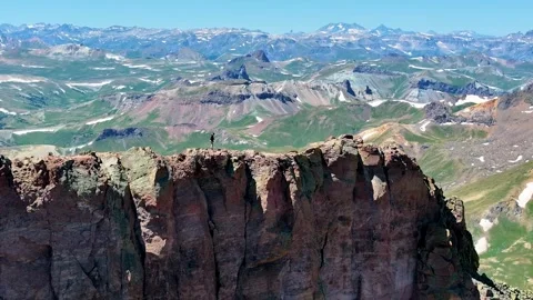 Man Walks on Mountain Peak 01 | Hikes to Cliff Edge | San Juan Range | 4K Drone Stock Footage 259892934