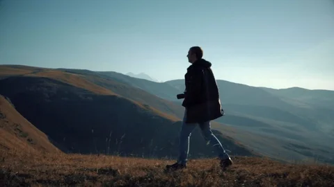 A man walks in the Mountain Ranges Stock Footage 98450858