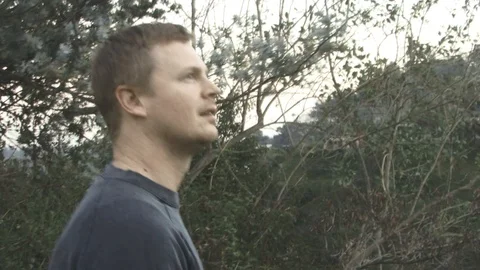 A man walks up a mountain side view. Video stock 99604942