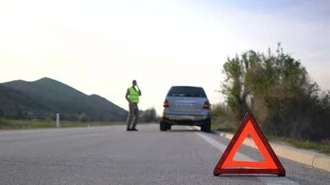 A man walks next to a broken car Video stock 74430382