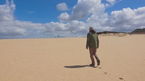 Man Walks on an Ocean Beach Stock Footage 90093825