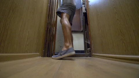 Man walks into an old elevator, shuts door and ascends. Stock Footage 93465132
