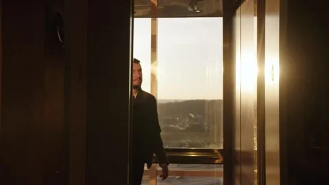 Man walks out of elevator Stock Footage 139719698