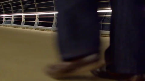A man walks over the bridge. Bottom view Stockbeeldmateriaal 100583017