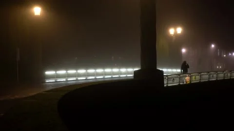 Man walks over bridge at night Stock Footage 145156752