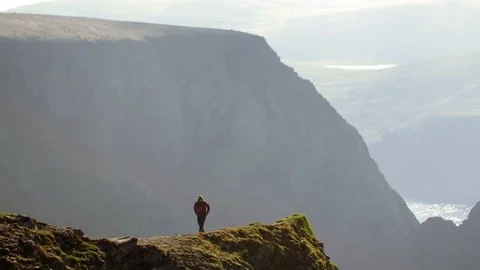 Man walks over cliffs at the North Cape area Stockbeeldmateriaal 70190973