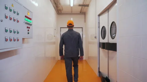 A man walks into a production workshop Stock Footage 145691520