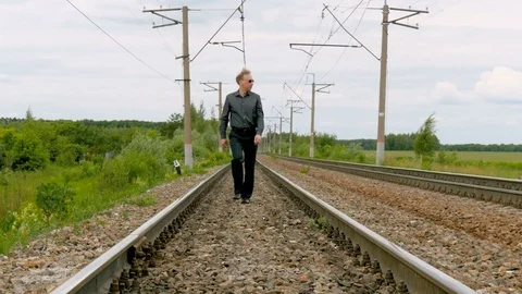 A man walks by rail. Stock-Footage 77228871