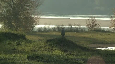 Man walks by the river Stock Footage 21727602
