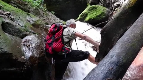 A man walks up the riverbed. Video stock 137556898