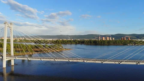 A man walks on a rope stretched between the supports of the bridge at high Video stock 113142869