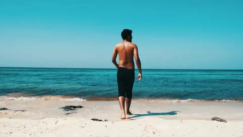 Man walks into sea 스톡 동영상 210549313