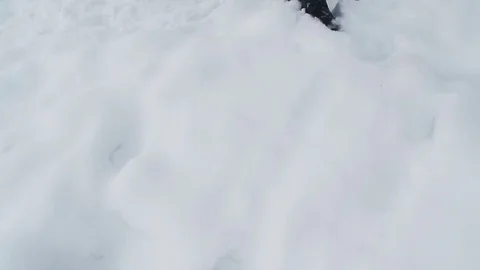 A man walks on a snow-covered path in daytime Stock Footage 76597384