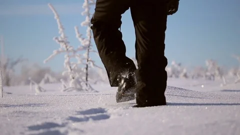 A man walks in the snow Stock Footage 71583058