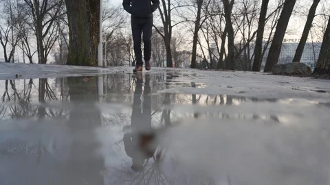 A man walks in spring on melting snow Stock Footage 103120552