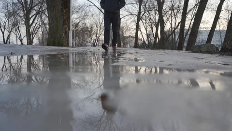 A man walks in spring on melting snow Stock Footage 103120590