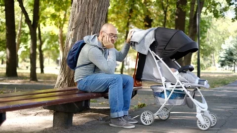 A man walks with a stroller in the park. Stock Footage 118690602