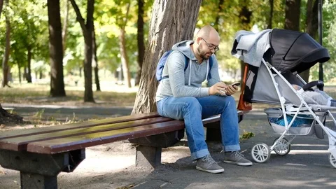 Man walks with a stroller in the park. Stock Footage 118690614