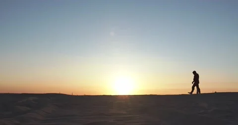 A man walks at sunset Видео 157102601