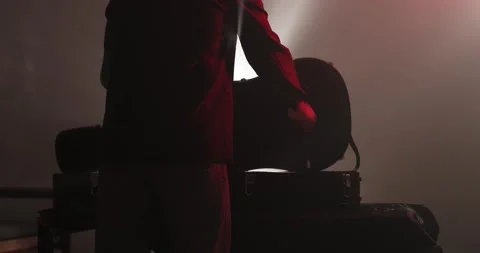 Man walks up to table and opens guitar case pulls out cleissic guitar in dark Video stock 179022818