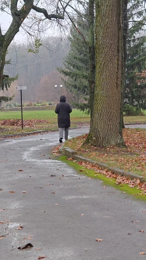 A man walks through an autumn park dancing Stock Footage 321615246