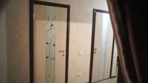 Man walks through the corridor to the door Stock Footage 81388487