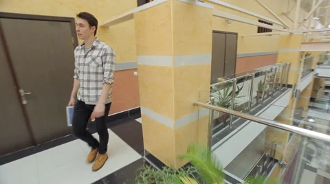 Man walks through corridors in empty shopping mall Stock Footage 65660390