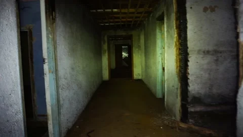 Man walks through dark abandoned house with flashlight Stock Footage 152612708