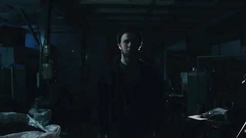Man walks through a dark room Video stock 76492555